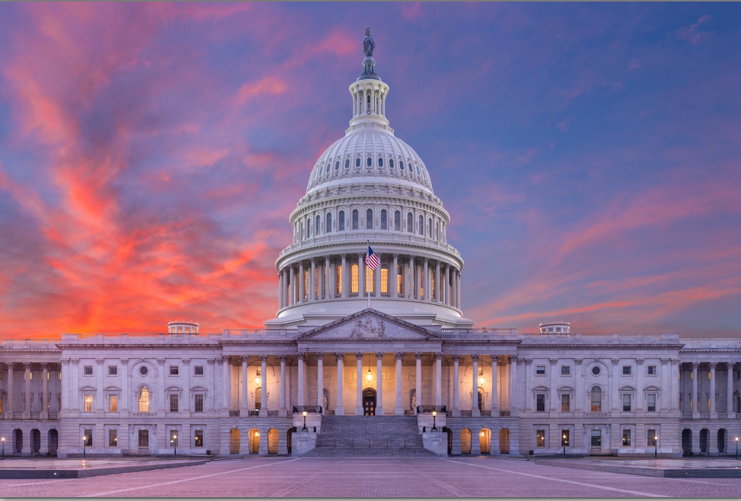 The United States Capitol beneath a colorful sunset sky